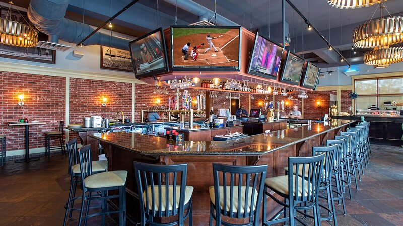Bar with seating and multiple televisions